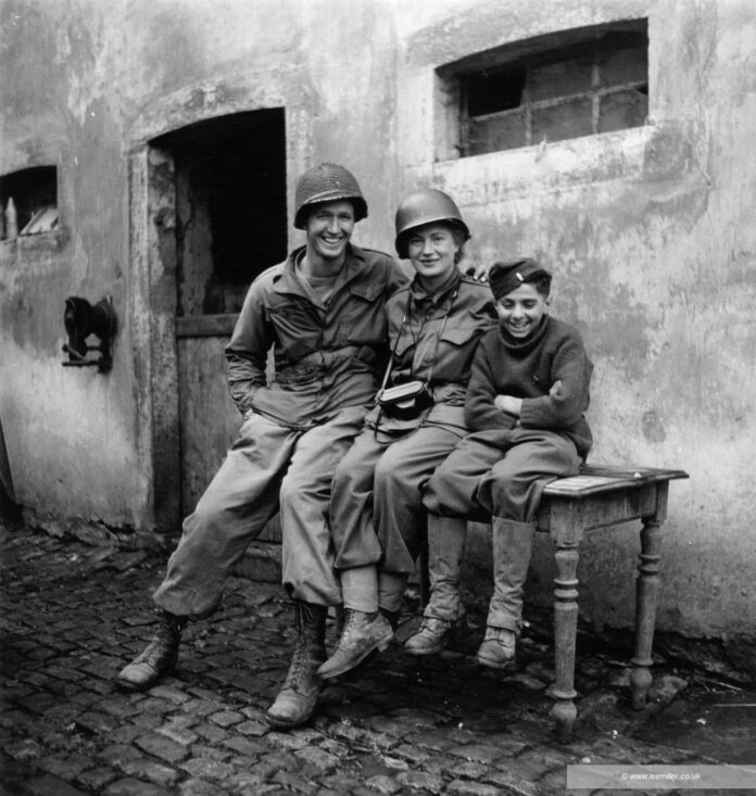 Me with smallest and tallest (Lee Miller with Jean Peltier and Sergeant Robert Burchfield)